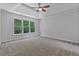 Main bedroom has a tray ceiling, carpet, and large windows with a view at 2934 Mill Grove Ter, Dacula, GA 30019
