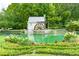 Scenic community pond featuring a decorative water wheel, landscaping, and lush greenery at 2934 Mill Grove Ter, Dacula, GA 30019