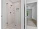 Modern walk-in shower featuring glass doors, white tile, and a convenient built-in niche at 2934 Mill Grove Ter, Dacula, GA 30019