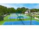A view of the community tennis courts with shaded benches for players at 2934 Mill Grove Ter, Dacula, GA 30019