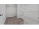Spacious walk-in closet with neutral carpet and white shelving units at 2934 Mill Grove Ter, Dacula, GA 30019