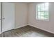 Bright bedroom featuring wood floors, a closet, and a large window at 3812 Clare Ct, Duluth, GA 30096