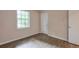 This bedroom features hardwood floors, a neutral wall color, and a bright window at 3812 Clare Ct, Duluth, GA 30096