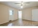 Bedroom featuring light-colored walls, wood floors, ceiling fan, and a door at 3812 Clare Ct, Duluth, GA 30096