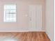 Entryway featuring wood-look flooring, a bright window, and a white door at 3812 Clare Ct, Duluth, GA 30096