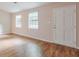 Spacious entry area with wood-look flooring, bright windows, and a white door at 3812 Clare Ct, Duluth, GA 30096