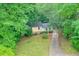 Aerial view of a charming home surrounded by lush greenery at 3812 Clare Ct, Duluth, GA 30096