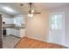 Open kitchen featuring white cabinets, granite counters, stainless steel appliances, and ceiling fan at 3812 Clare Ct, Duluth, GA 30096