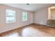 Comfortable living area featuring wood-look flooring, two windows, and stairs to the second level at 3812 Clare Ct, Duluth, GA 30096