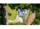 Stunning aerial view shows a lush property featuring a well-maintained home, patio, and mature trees at 4070 Whitewater Creek Rd, Atlanta, GA 30327