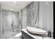 Modern bathroom featuring a glass shower, unique sink and marble walls at 4070 Whitewater Creek Rd, Atlanta, GA 30327
