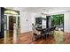 Dining room with a black marble table, modern chairs, and a view of the living area with a fireplace at 4070 Whitewater Creek Rd, Atlanta, GA 30327