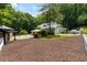 Home exterior features a manicured lawn, ample parking, and an outdoor grilling area, creating an inviting atmosphere at 4070 Whitewater Creek Rd, Atlanta, GA 30327