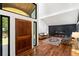 Welcoming foyer featuring a hardwood floor, a modern fireplace, and a grand wooden front door at 4070 Whitewater Creek Rd, Atlanta, GA 30327