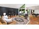 A modern living room featuring a black marble fireplace, hardwood floors, and plenty of natural light at 4070 Whitewater Creek Rd, Atlanta, GA 30327