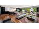 A spacious living room with a modern kitchen, marble accents, and an outdoor patio area with a fireplace at 4070 Whitewater Creek Rd, Atlanta, GA 30327