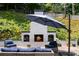 Inviting patio area boasts a cozy brick fireplace with wood storage, perfect for relaxed outdoor entertaining at 4070 Whitewater Creek Rd, Atlanta, GA 30327