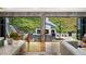 Outdoor patio with a fireplace and comfortable seating surrounded by lush greenery at 4070 Whitewater Creek Rd, Atlanta, GA 30327