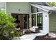Inviting patio area with seating, seamlessly connected to the home through large bi-folding doors and bright windows at 4070 Whitewater Creek Rd, Atlanta, GA 30327