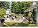Charming outdoor patio featuring comfortable seating, a stylish umbrella, and a brick fireplace for cozy gatherings at 4070 Whitewater Creek Rd, Atlanta, GA 30327