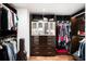 Spacious walk-in closet featuring custom shelving, drawers and hardwood floors at 4070 Whitewater Creek Rd, Atlanta, GA 30327