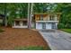 Charming two-story home with white brick, a balcony and a well-manicured lawn at 4260 Bonaparte Dr, Tucker, GA 30084