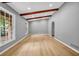 Bright living room featuring hardwood floors, exposed beams, and large windows at 4260 Bonaparte Dr, Tucker, GA 30084