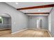 Spacious living room featuring hardwood floors, exposed beams, and arched doorways at 4260 Bonaparte Dr, Tucker, GA 30084