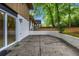 Back patio featuring a white brick retaining wall and a view of the trees surrounding the property at 4260 Bonaparte Dr, Tucker, GA 30084