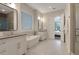 Bathroom with dual vanities, soaking tub, and glass shower at 904 Urban Ash Ct, Johns Creek, GA 30022