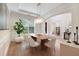 Bright dining room with hardwood floors, decorative lighting and an elegant dining table and chairs at 904 Urban Ash Ct, Johns Creek, GA 30022