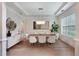 Stylish dining room with modern chandelier, hardwood flooring, and ample natural light at 904 Urban Ash Ct, Johns Creek, GA 30022