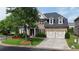 Charming two-story home with manicured landscaping, a stone and brick facade, and a two-car garage at 904 Urban Ash Ct, Johns Creek, GA 30022