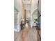 Bright foyer featuring hardwood floors, a high ceiling, an arched doorway, and views of the staircase at 904 Urban Ash Ct, Johns Creek, GA 30022