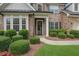 Close-up of the front exterior, showing a well-manicured lawn and a brick-and-stone facade at 904 Urban Ash Ct, Johns Creek, GA 30022