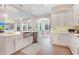 Bright, white kitchen with stainless appliances and views to the breakfast area at 904 Urban Ash Ct, Johns Creek, GA 30022