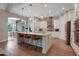Spacious kitchen with an island, pendant lighting, white cabinetry and stainless steel appliances at 904 Urban Ash Ct, Johns Creek, GA 30022