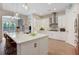Well-lit kitchen with a center island, stainless steel appliances, and bright white cabinets at 904 Urban Ash Ct, Johns Creek, GA 30022