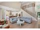Bright, open-concept living space seamlessly connects to the modern kitchen and features hardwood floors at 904 Urban Ash Ct, Johns Creek, GA 30022