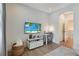 Bright living room with a TV, desk, and decorative elements, creating a cozy workspace at 904 Urban Ash Ct, Johns Creek, GA 30022