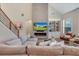 Cozy living room featuring a fireplace, vaulted ceiling, and seamless flow into the rest of the house at 904 Urban Ash Ct, Johns Creek, GA 30022