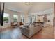 Open-concept living room with hardwood floors, vaulted ceiling, and seamless flow to the modern kitchen at 904 Urban Ash Ct, Johns Creek, GA 30022