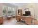 Bright office with hardwood floors, large windows, and a modern desk area perfect for working from home at 904 Urban Ash Ct, Johns Creek, GA 30022