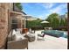 Outdoor patio with seating, a fire pit, and a glimpse of a sparkling pool at 904 Urban Ash Ct, Johns Creek, GA 30022
