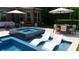 Inviting pool with in-pool loungers, spa, and outdoor dining area for summer enjoyment at 904 Urban Ash Ct, Johns Creek, GA 30022