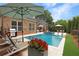 Swimming pool with lounge chairs and a well-manicured backyard at 904 Urban Ash Ct, Johns Creek, GA 30022
