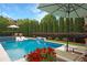 Gorgeous pool area with mature trees, outdoor seating, and manicured landscaping for entertainment at 904 Urban Ash Ct, Johns Creek, GA 30022