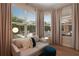 Comfortable sitting room with a couch overlooking the backyard and pool at 904 Urban Ash Ct, Johns Creek, GA 30022