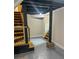 Finished basement area with painted floors, black support beams, and stairs at 1460 Hartford Sw Ave, Atlanta, GA 30310