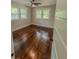 This bedroom offers natural light, hardwood flooring, and a ceiling fan for added comfort at 1460 Hartford Sw Ave, Atlanta, GA 30310